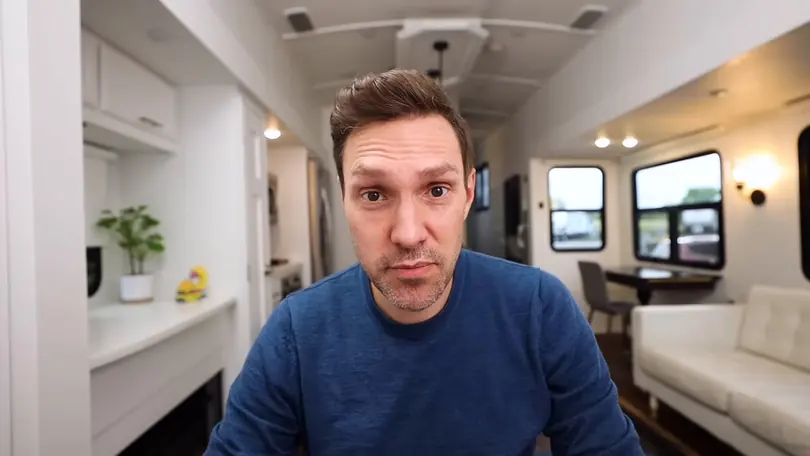Andy Bailey talks to the camera from the living area of his camper